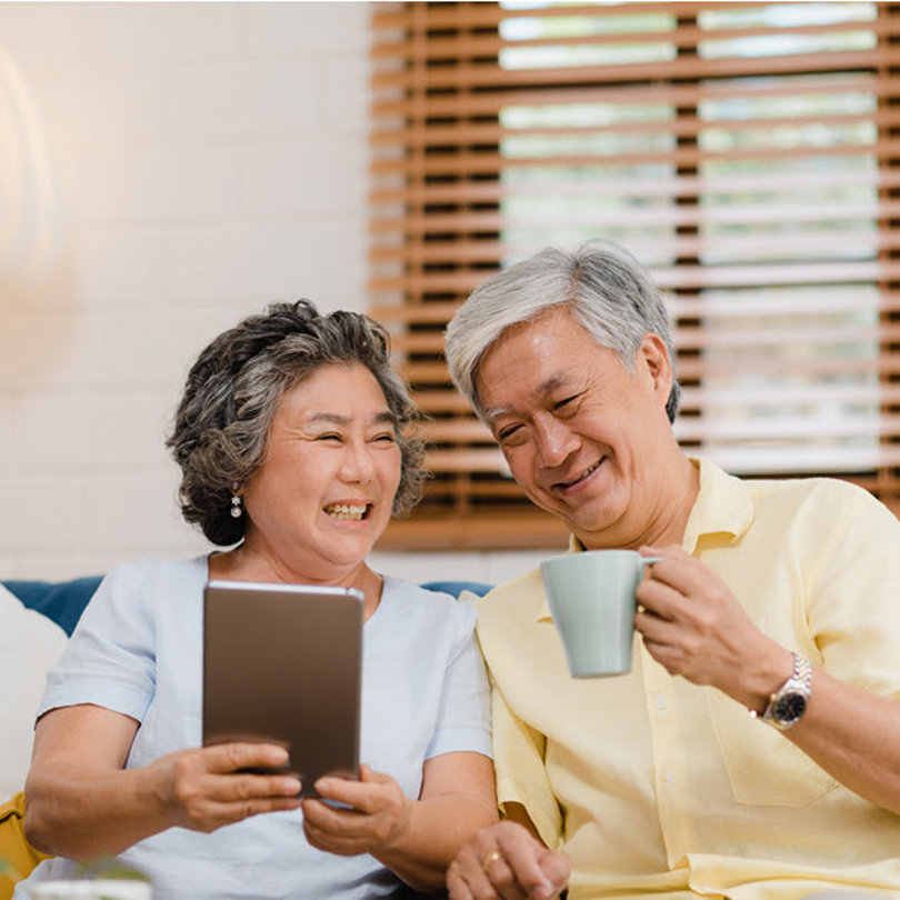 man woman smile at sofa